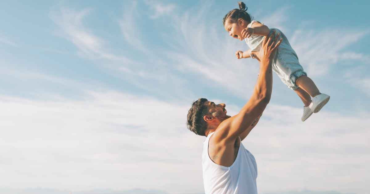father and child at the beach