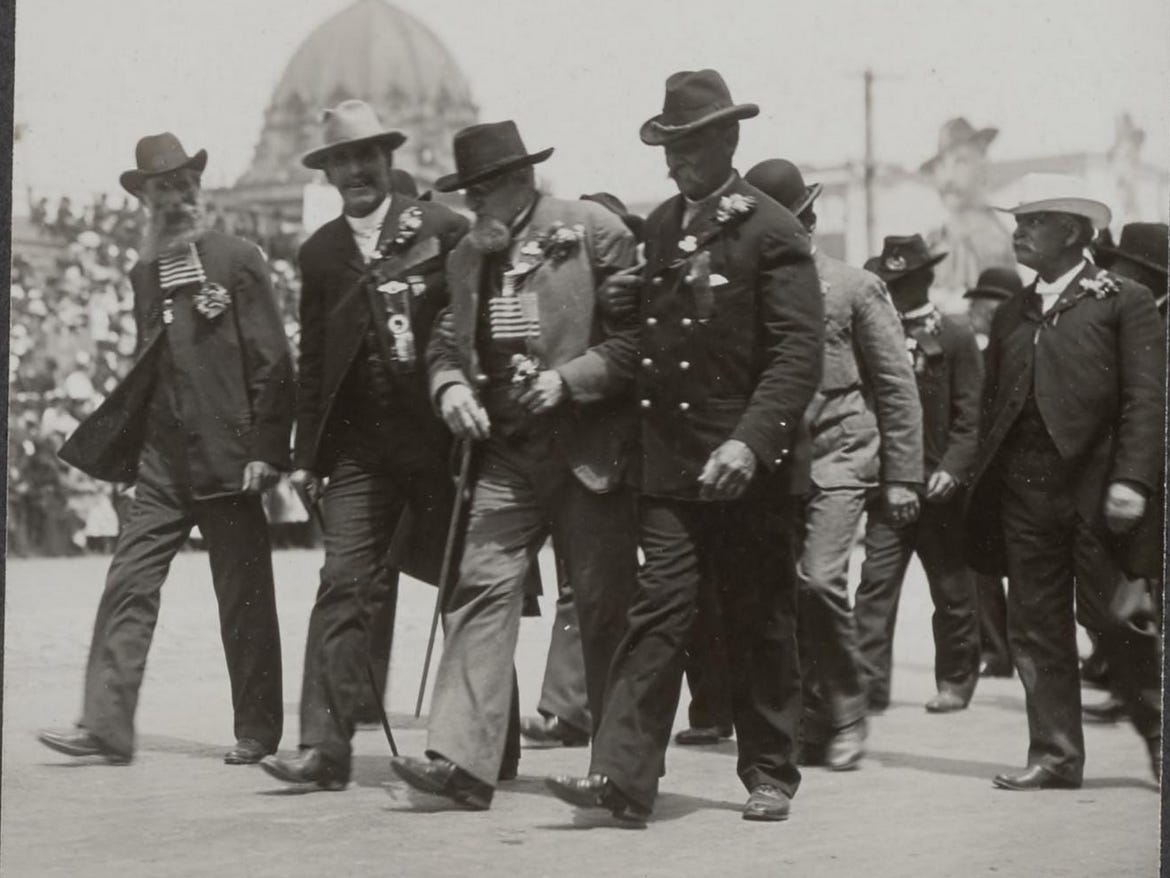 An aged Civil War veteran of the Grand Army of the Republic is assisted during a parade, San Francisco, 1903. An aged Civil War veteran of the Grand Army of the Republic is assisted during a parade, San Francisco, 1903.