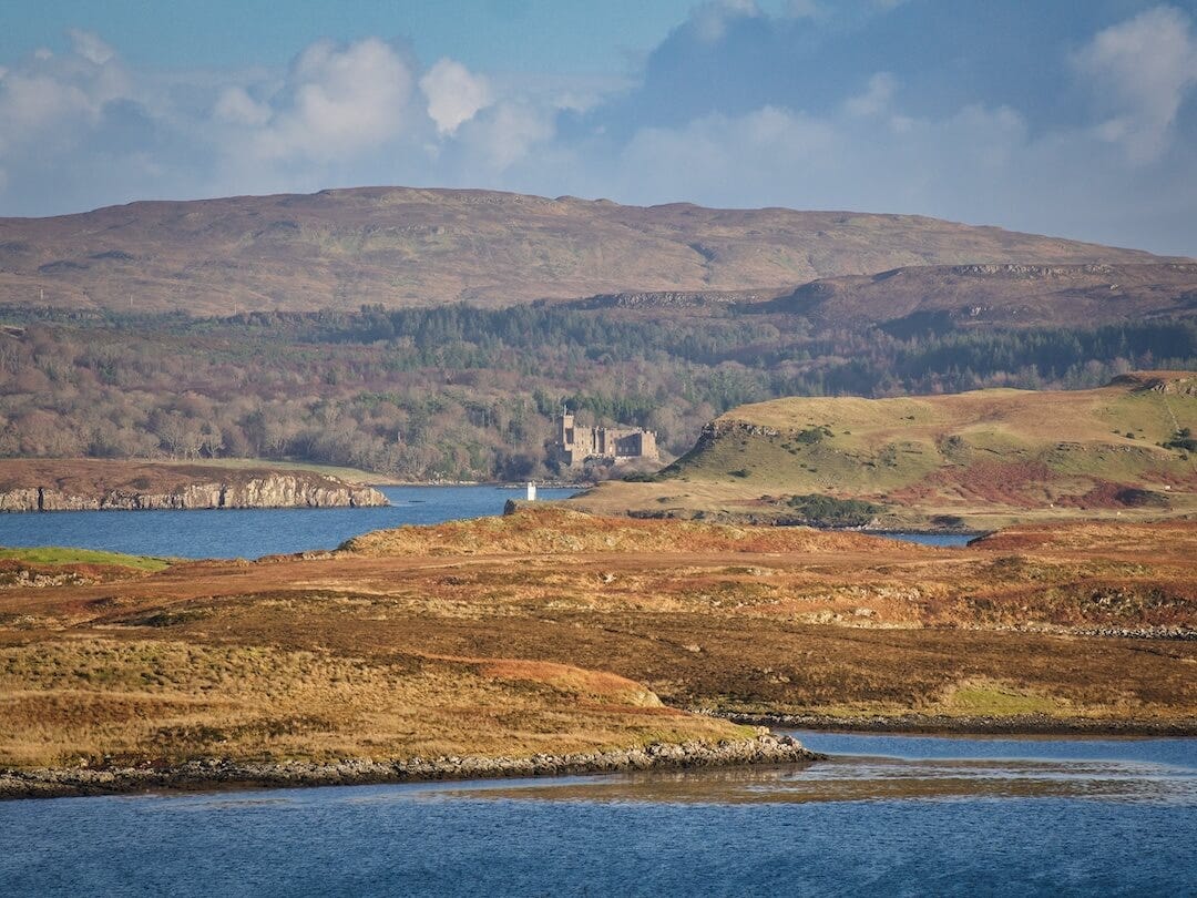 View of a castle across a loch filled with headlands