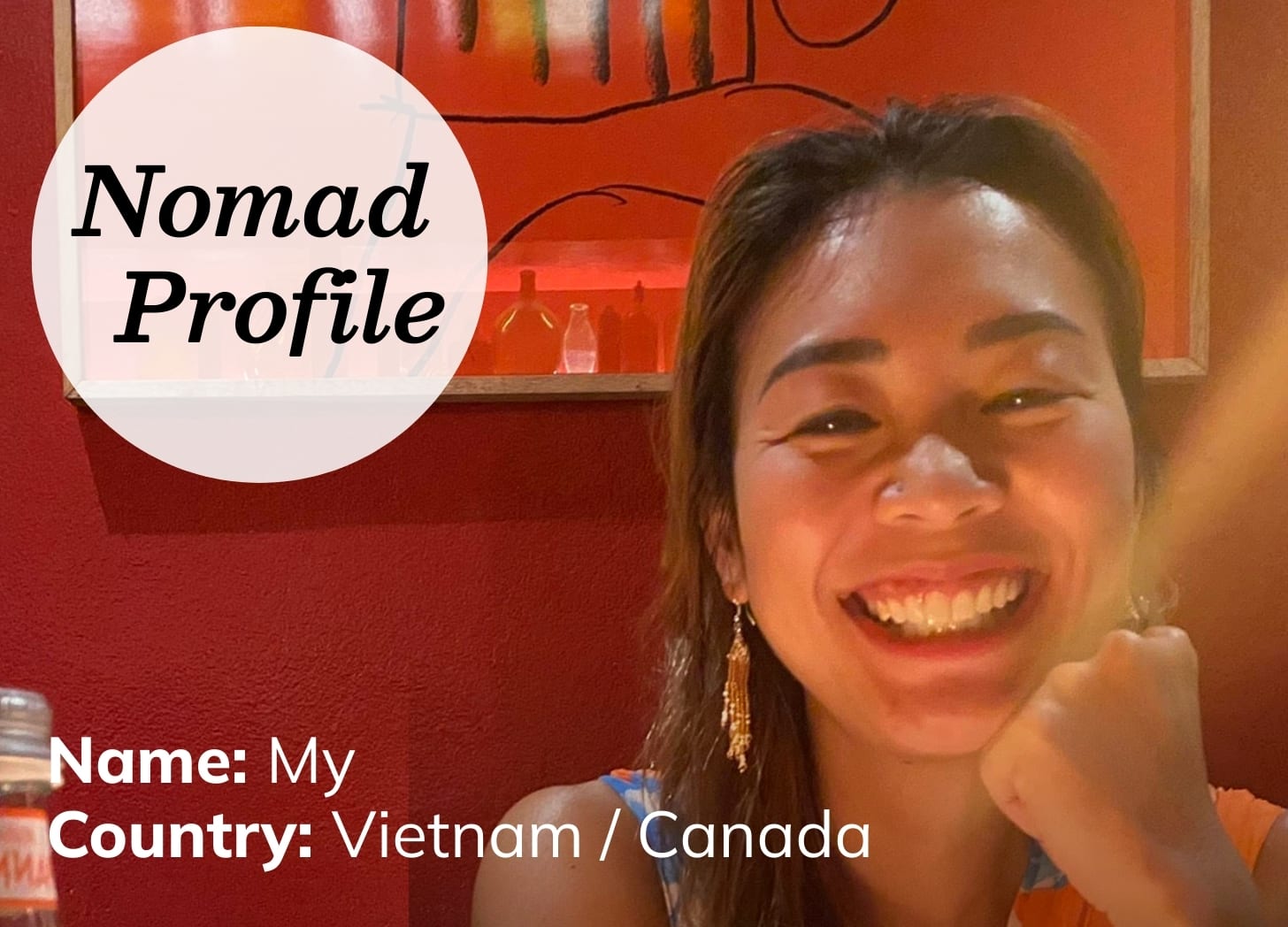 A young Asian woman is sitting in a dimly lit restaurant with a deep red interior. She has long black hair and a big smile. A young Asian woman is sitting in a dimly lit restaurant with a deep red interior. She has long black hair and a big smile.