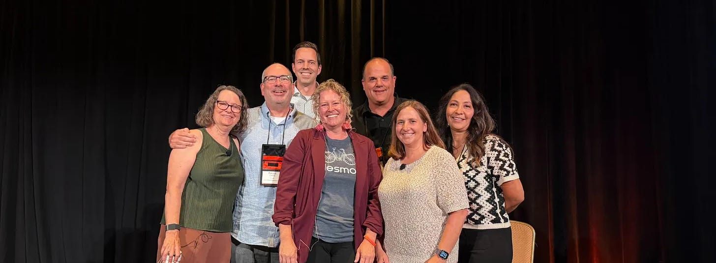 A group of people on a panel at a conference.