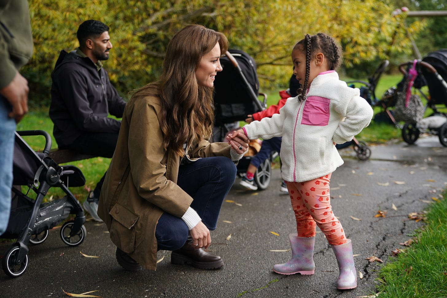Princess Catherine holding the hand of a child