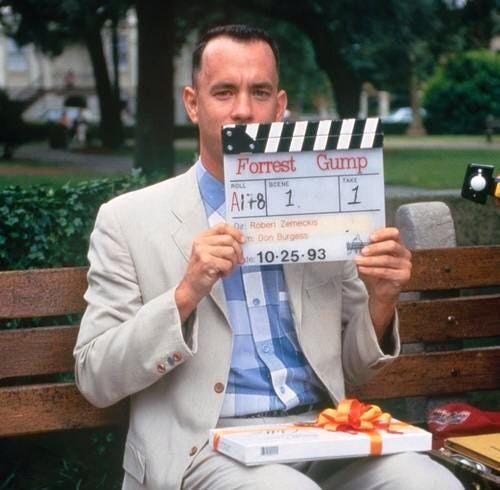 Tom Hanks as Forrest Gump, holding a movie clacker — the power of similes
