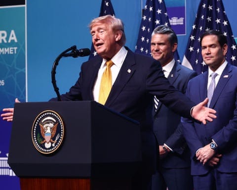 President Trump speaks at a podium with the presidential seal, flanked by two men in suits President Trump speaks at a podium with the presidential seal, flanked by two men in suits