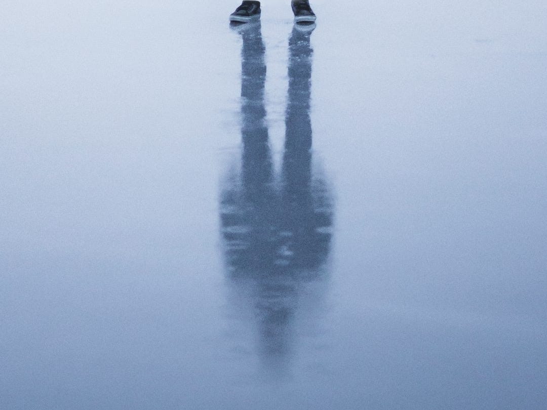person in black pants standing on water person in black pants standing on water
