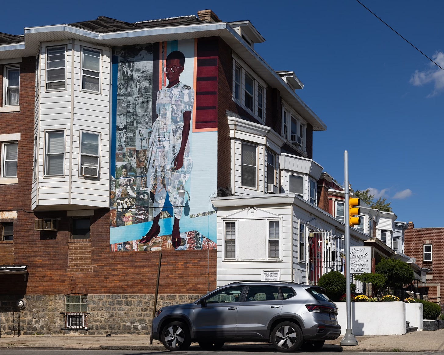 Njideka Akunyili Crosby, The Beautyful Ones, Series #1c, reproduced as a mural, 2025. Mural Arts Philadelphia and the Philadelphia Museum of Art, 5447 Chester Avenue, Kingsessing.
