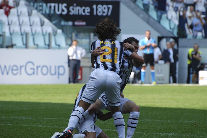 Juventus vs Parma, September 11, 2011: team huddle, player introductions, Antonio Conte coaching from the sideline, Pirlo and Del Piero in action, and Juventus players celebrating a goal during the opening match at Juventus Stadium.
