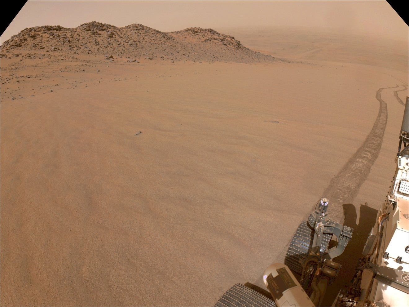 Pic of Mars Perseverance rover climbing the slopes of Jezero Crater. Rover tracks can be seen trailing off into the distance, back toward the crater’s floor. Pic of Mars Perseverance rover climbing the slopes of Jezero Crater. Rover tracks can be seen trailing off into the distance, back toward the crater’s floor.