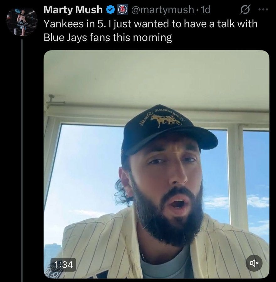 Screenshot displays a tweet interface with profile image of a man, username Marty Mush, verified badge, and text stating Yankees 5-1 followed by I just wanted to have a talk with Blue Jays fans this morning have a talk. Below is a video thumbnail showing Marty Mush, a man with long hair and beard, wearing a black cap with gold logo, striped shirt, standing near a window with blue sky outside, mouth open expressively. Video duration indicated as 1:34 with play button overlay.
