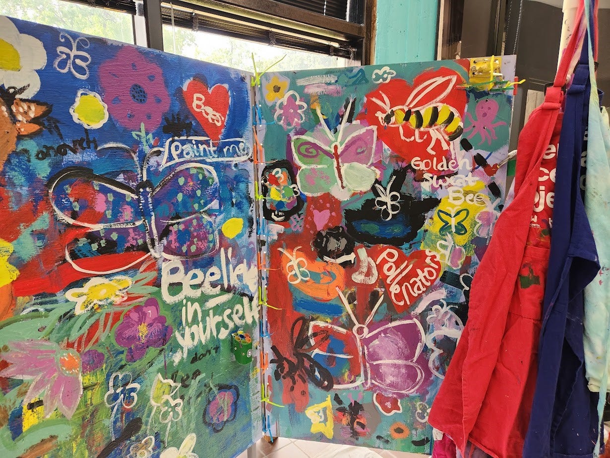 Bee Fest mural with various colorful pollinators painted on it.