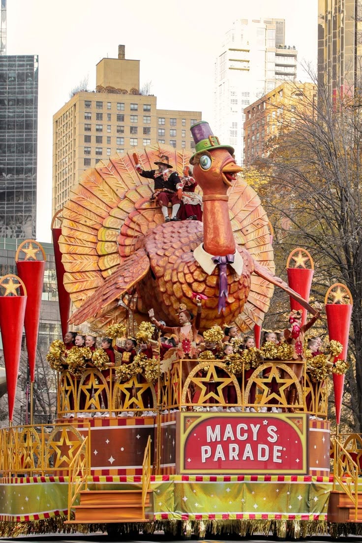 This may contain: an elaborate float in the macy's parade, with large turkey on top and two red fire extinguishers