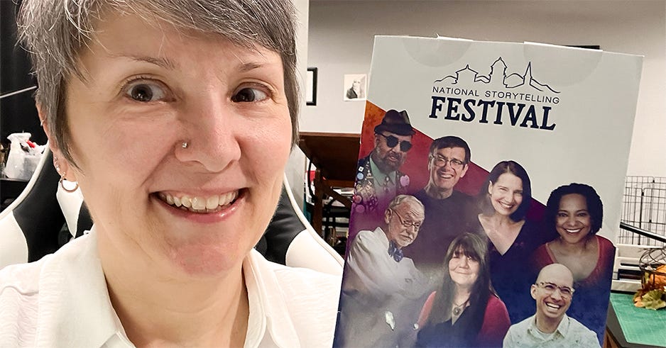 Author smiling and holding a colorful flyer, standing indoors with warm autumn light; image for International Storytelling Festival announcement.