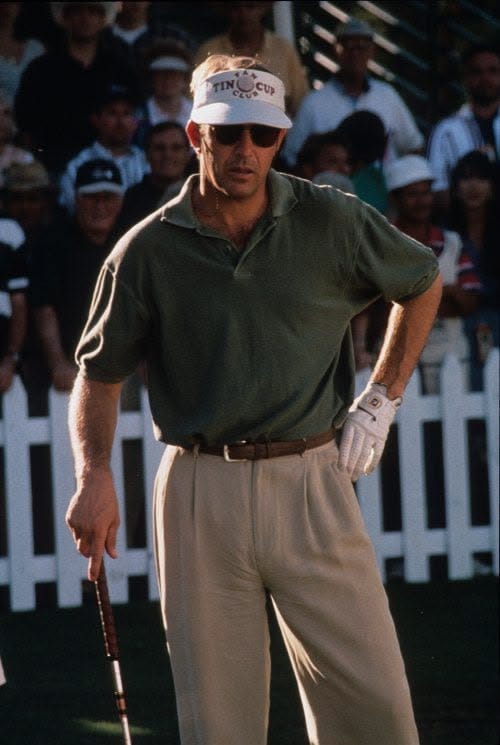 This may contain: a man holding a golf club in his right hand and wearing a visor on top of his head This may contain: a man holding a golf club in his right hand and wearing a visor on top of his head