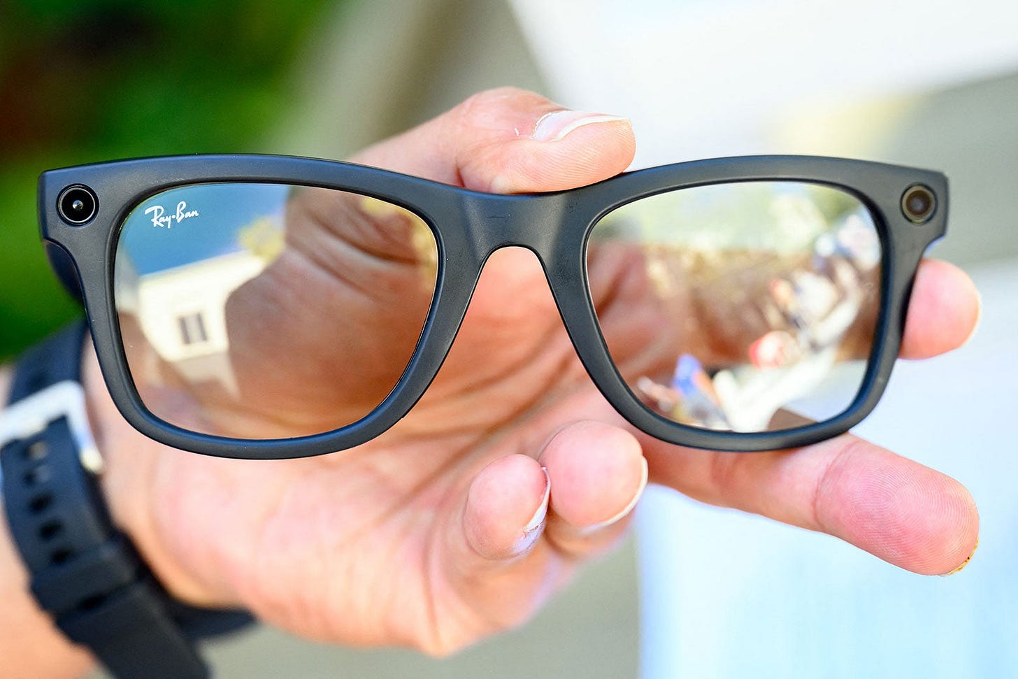 A person holding Meta AI's new Ray-Ban glasses. A person holding Meta AI's new Ray-Ban glasses.