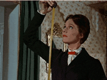 a woman is measuring something with a tape measure in a room a woman is measuring something with a tape measure in a room