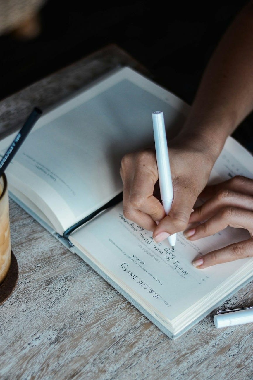 person writing on book