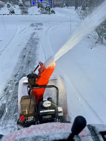 A snow blower spraying snow on a road

AI-generated content may be incorrect.
