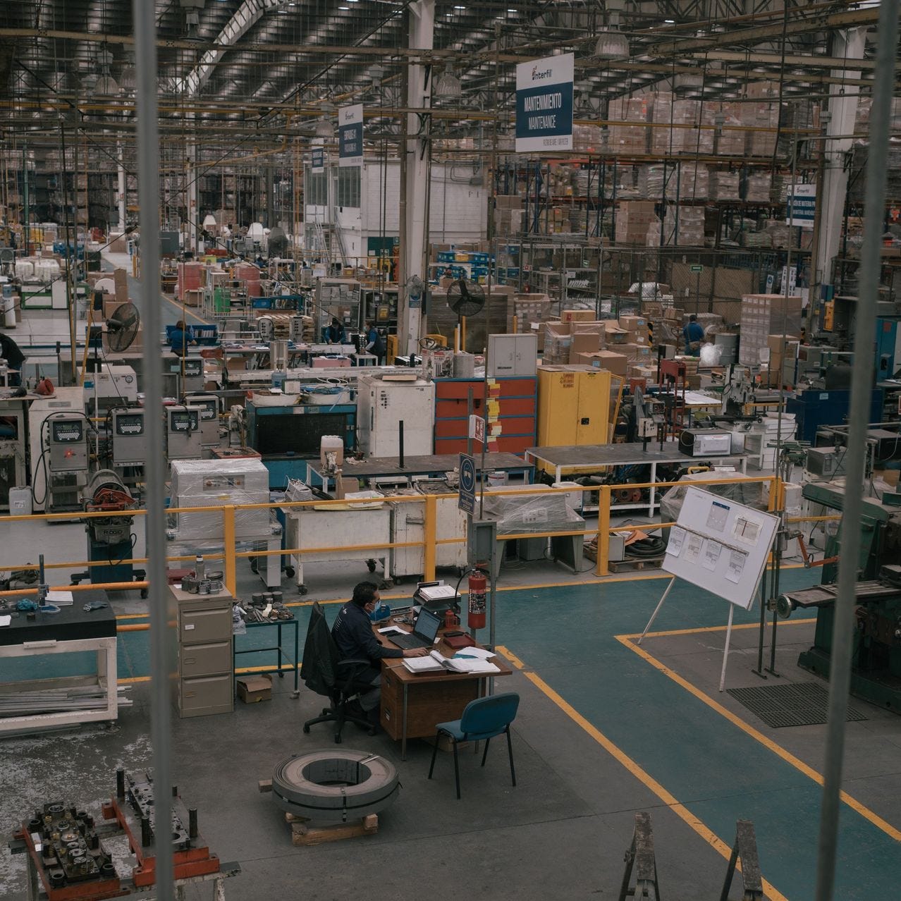 A worker sits at his desk at an Interfil automotive-parts factory in Tultitlán de Mariano Escobedo, Mexico, owned by Premium Guard.