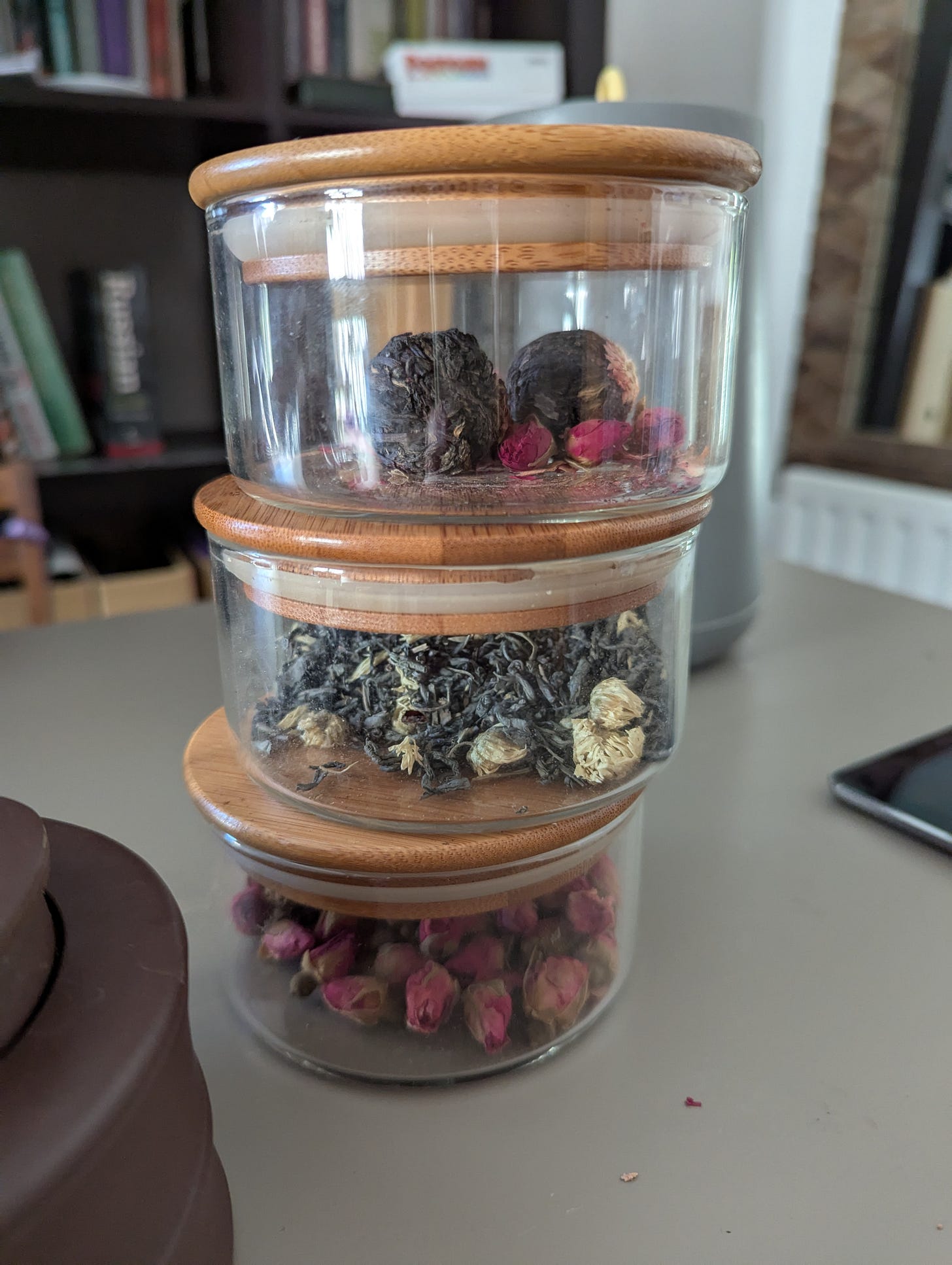 Three pots with Asian teas stacked on top of each other.