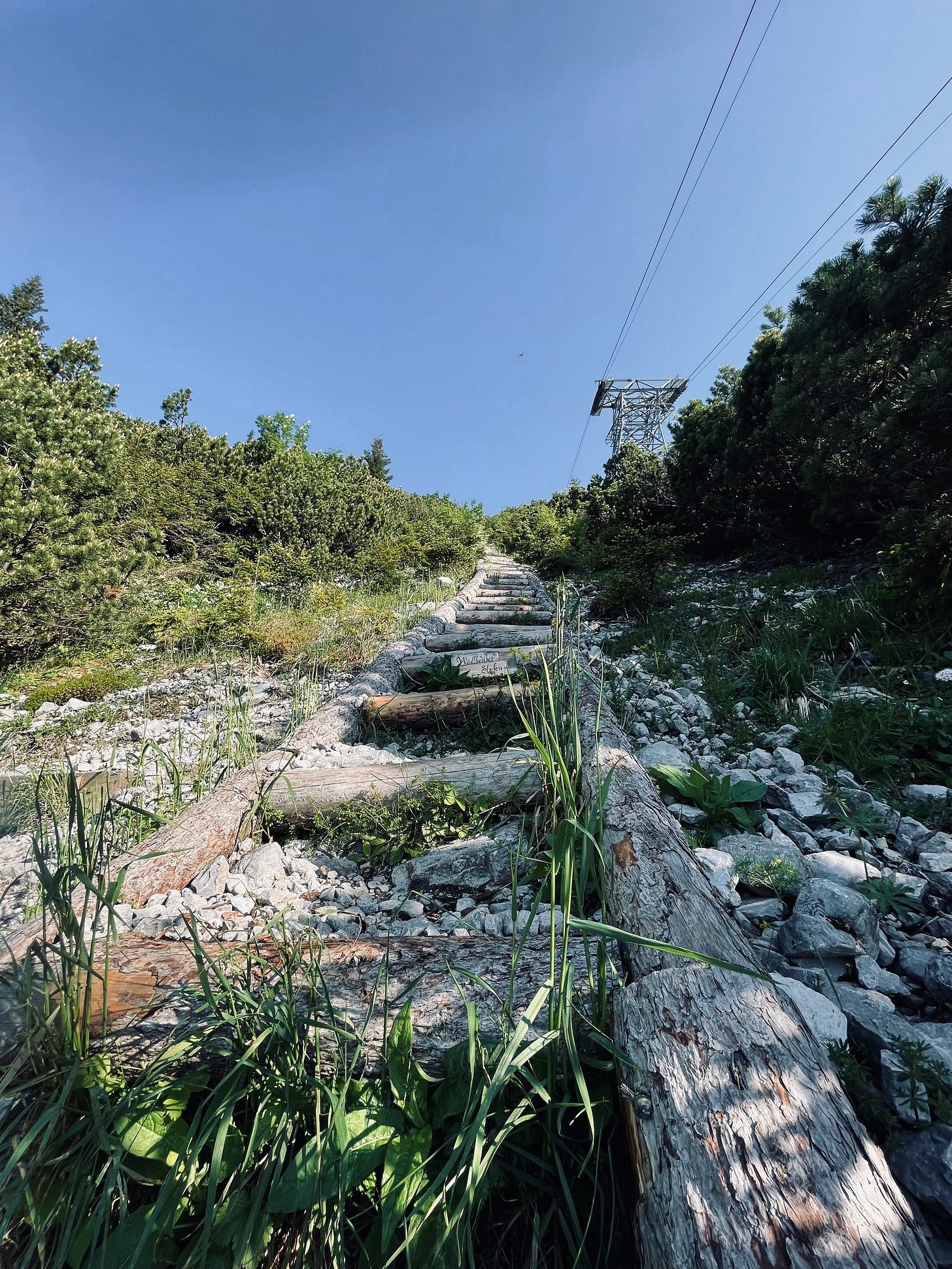 very steep wooden stairs right next to a cable car