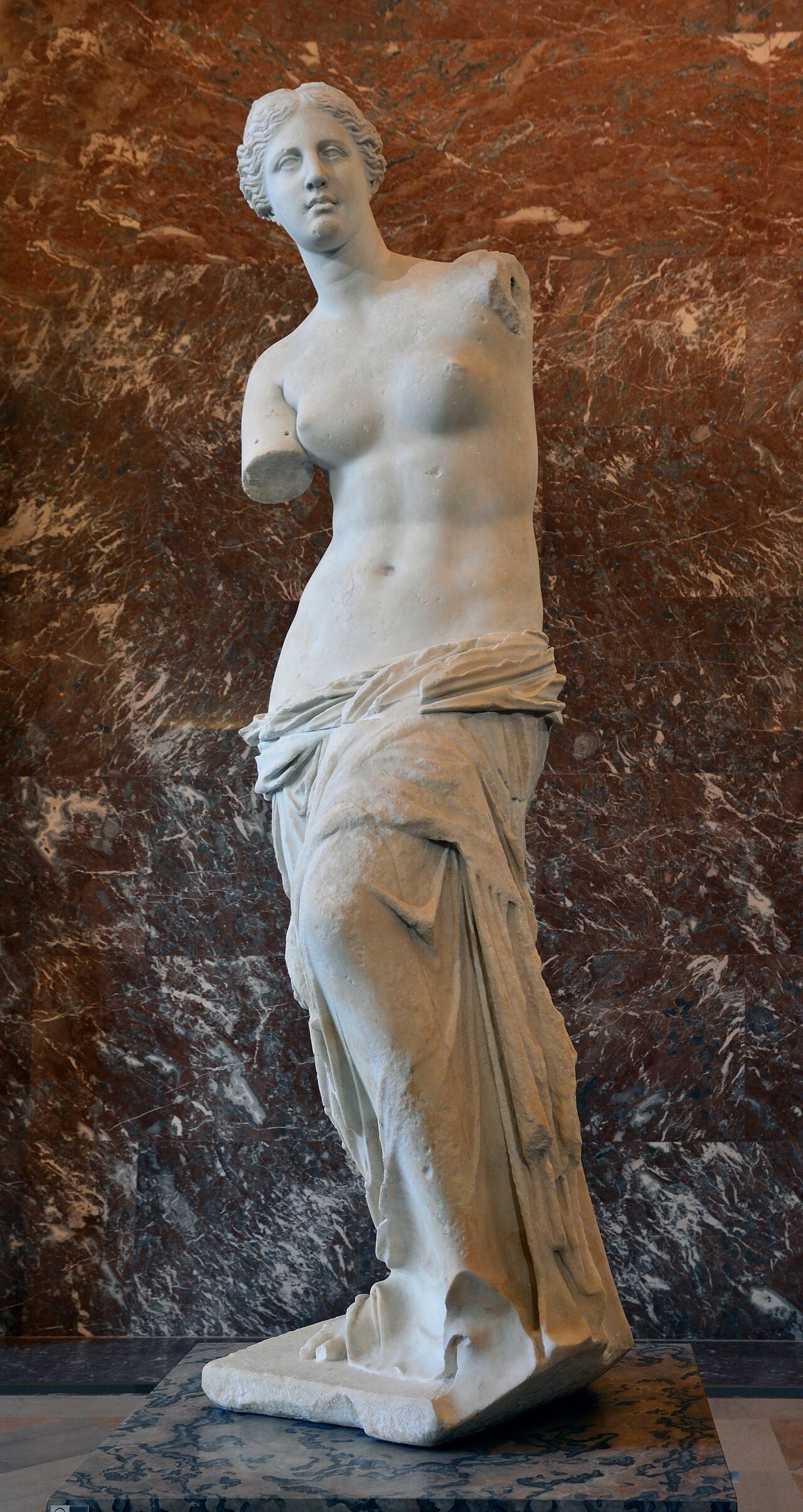 The Venus de Milo, a marble statue of Aphrodite with both arms missing, in the Louvre The Venus de Milo, a marble statue of Aphrodite with both arms missing, in the Louvre