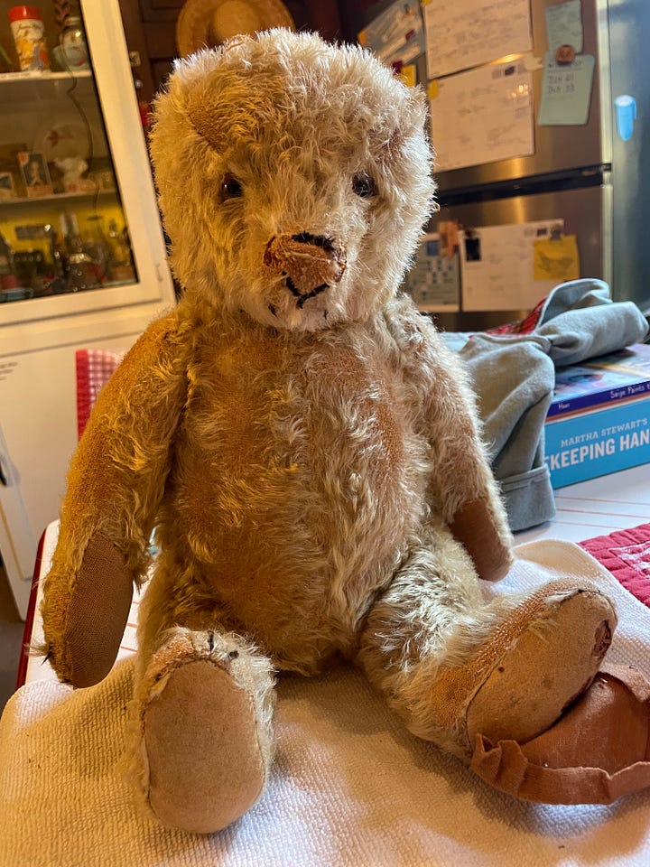 An antique teddy bear being repaired.