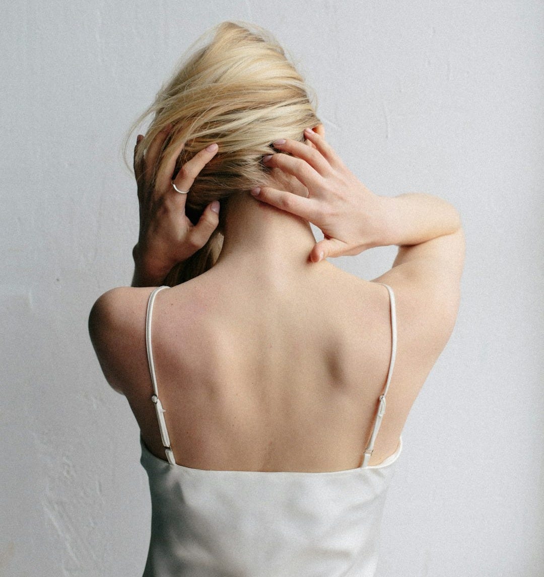 woman in white spaghetti strap top covering her face woman in white spaghetti strap top covering her face