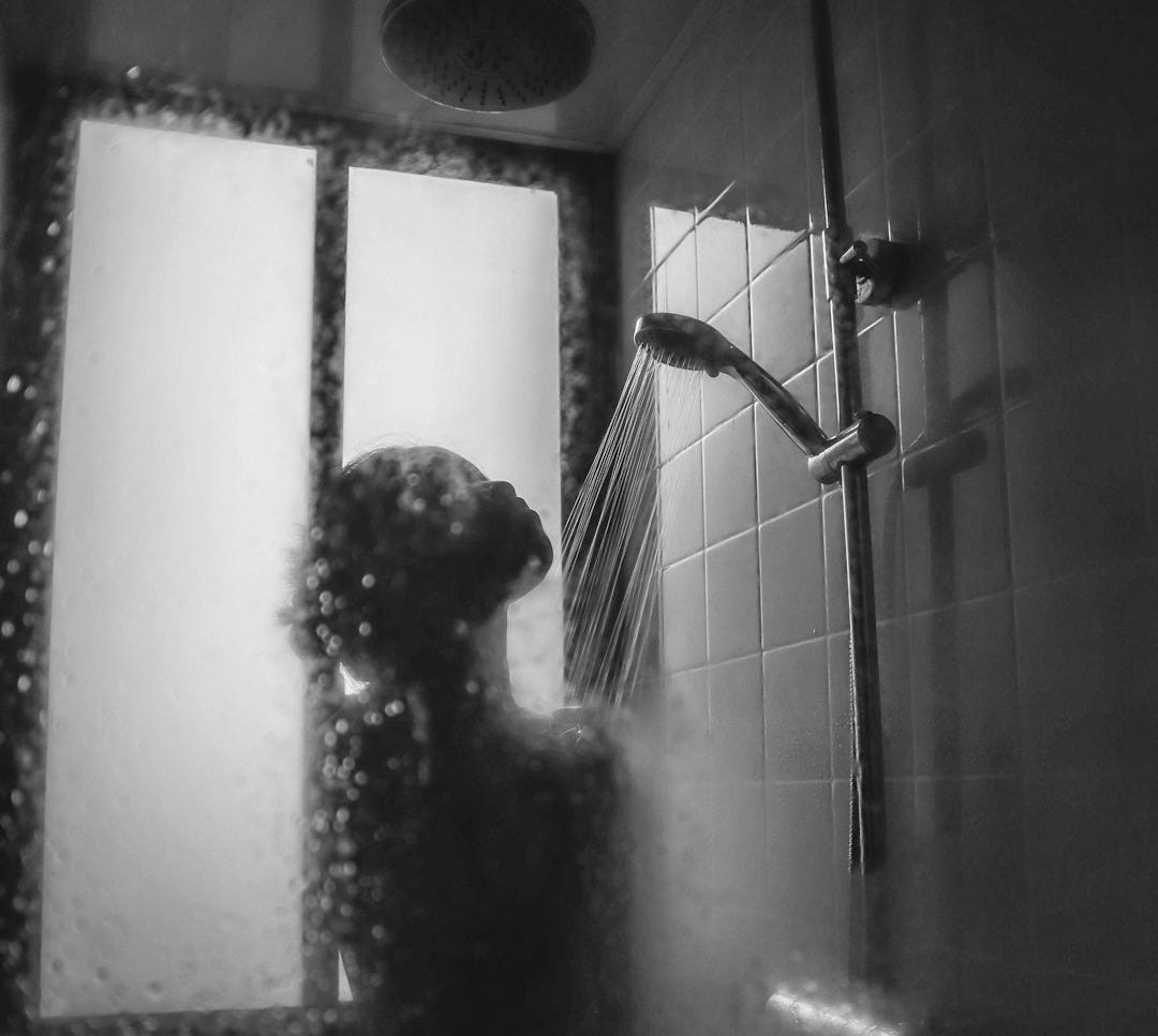 woman under showerhead
