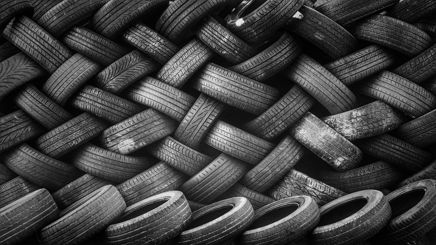 A large pile of rubber car tires A large pile of rubber car tires