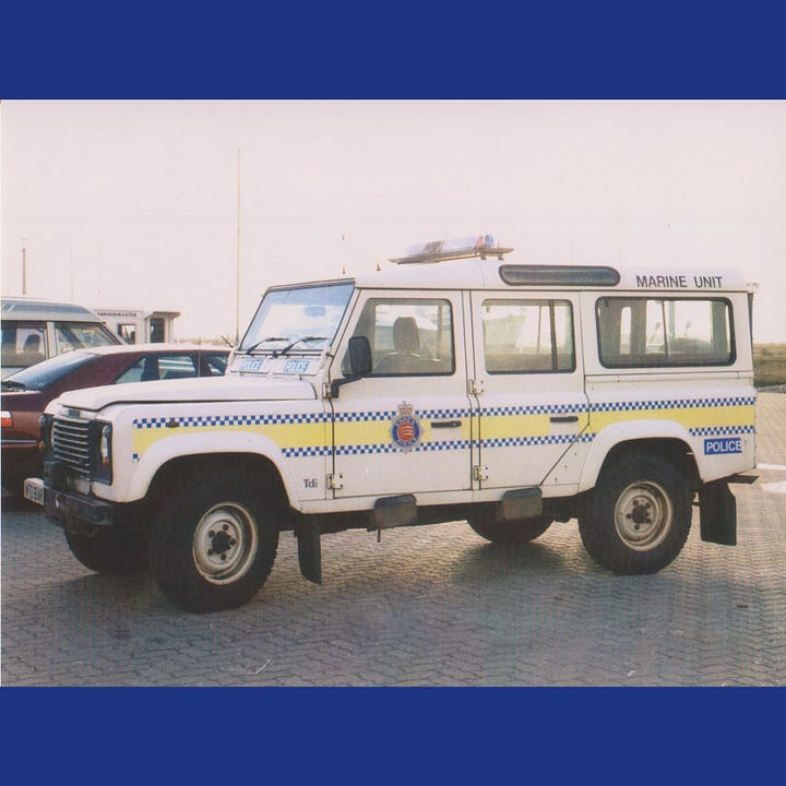 A 1960s camper van striped out filled with a winch and other equipment, a land rover defender in Essex Police livery and the modern marine unit long van with attached awning.