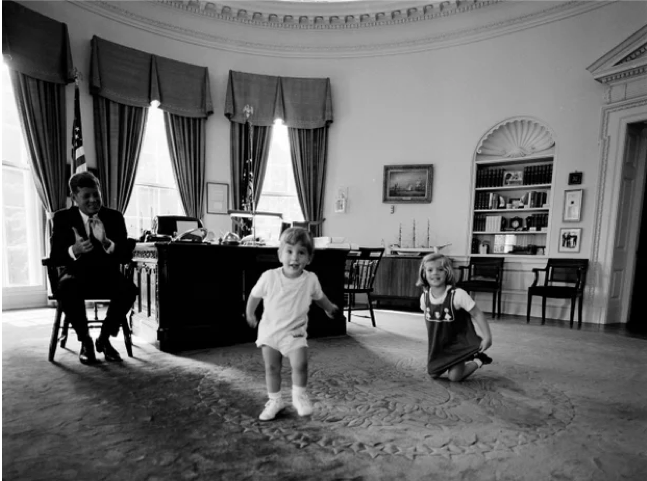President Kennedy with Caroline Kennedy and John F. Kennedy, Jr. in the Oval Office, October 10, 1962.
