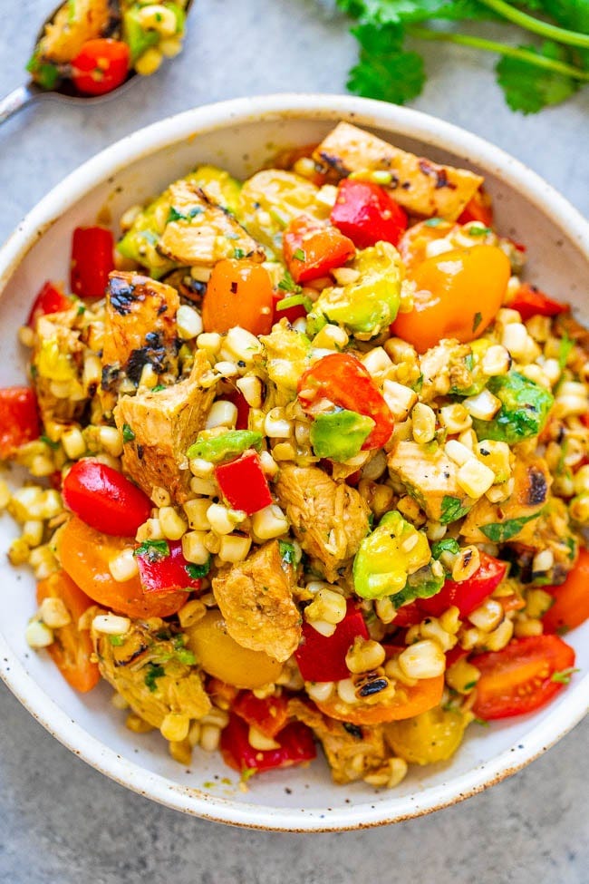 Grilled Chicken and Corn Salad - An EASY salad that’s ready in 15 minutes and you won’t be able to stop eating it!! Tender chicken, juicy corn, crisp bell peppers and tomatoes, creamy avocado, cilantro, and fresh lime juice for the WIN!! Grilled Chicken and Corn Salad - An EASY salad that’s ready in 15 minutes and you won’t be able to stop eating it!! Tender chicken, juicy corn, crisp bell peppers and tomatoes, creamy avocado, cilantro, and fresh lime juice for the WIN!!