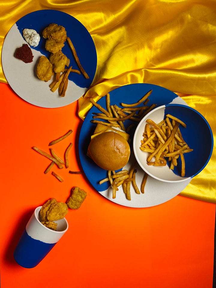 4 images. Product photography of bamboo plates with fake ice cream, roasted chicken dinner, tomato soup and sandwiches and a hamburger meal with fries as lifestyle shots.