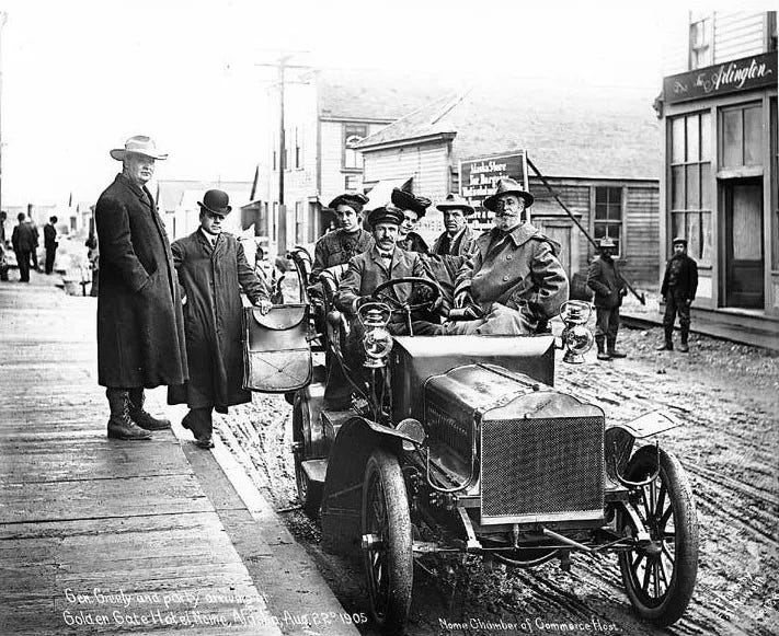 A car on a muddy street in Nome, Alaska in 1905, during the Nome gold rush.
