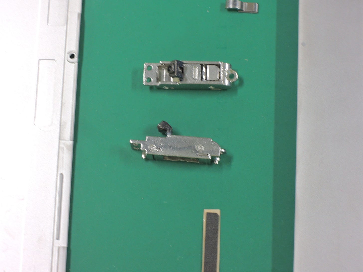 Photograph of the Surface kickstand hinge looking at two different angles. Photograph of the Surface kickstand hinge looking at two different angles.