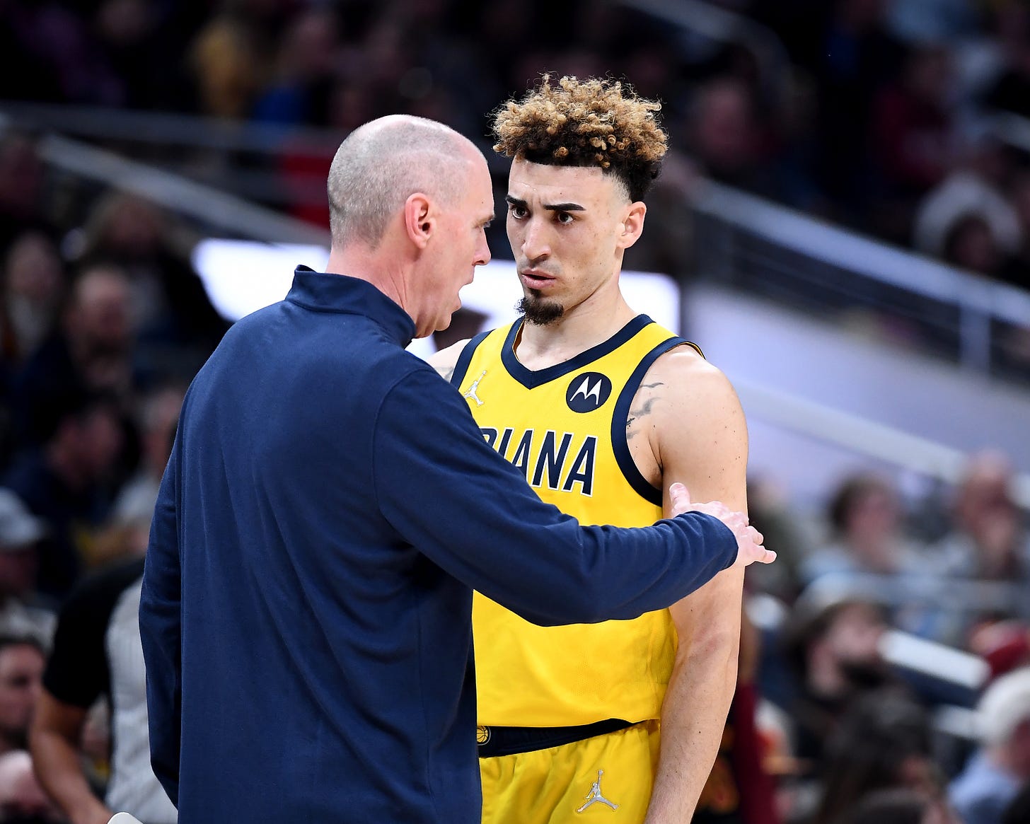 Pacers head coach Rick Carlisle talks with Chris Duarte on the sideline.