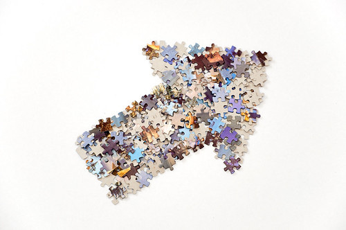 Thick arrow made from jigsaw puzzle pieces Thick arrow made from jigsaw puzzle pieces