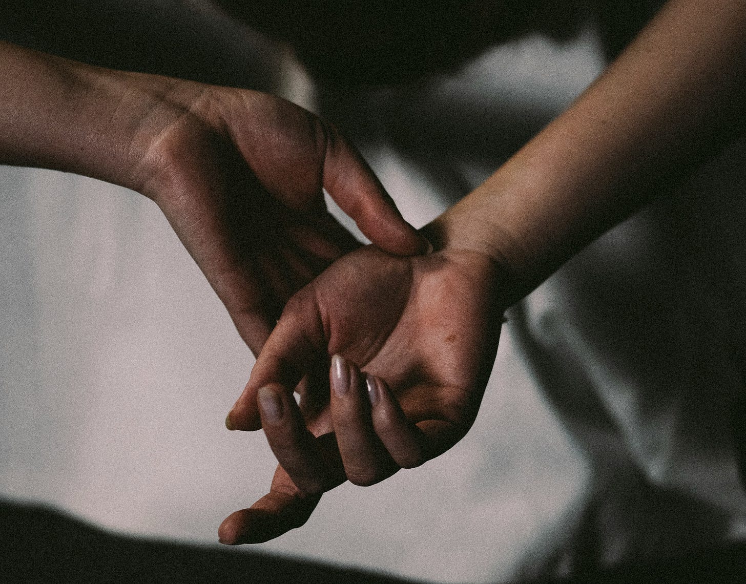 a grainy film photo of hands