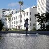 A woman in Miami Beach, Fla. walks past street flooding from a high tide.