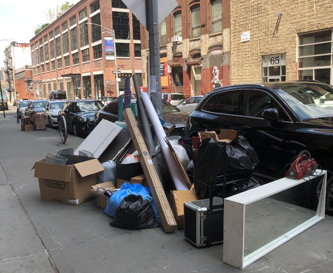 A pile of trash on the sidewalk

AI-generated content may be incorrect.