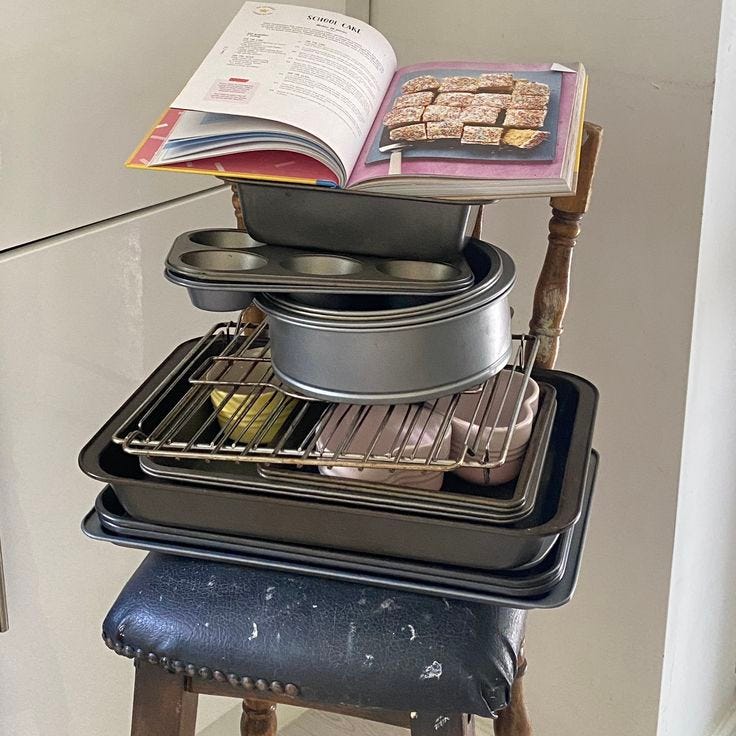 This may contain: a stack of pans sitting on top of each other in front of an open book