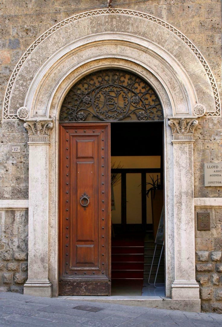 This may contain: an entrance to a building with a wooden door