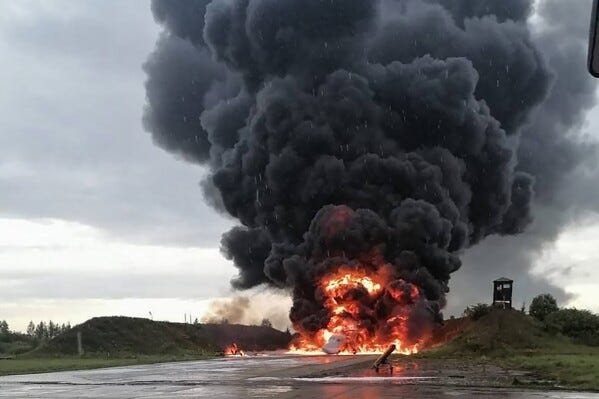 In this image released by Sirena telegram channel on Sunday, Aug. 20, 2023, a Russian warplane is burning on the Soltsy air base in the Novgorod region in northwestern Russia. Ukrainian saboteurs coordinated by Kyiv's military intelligence services carried out a pair of recent drone attacks that hit parked bomber aircraft at air bases deep inside Russia, Ukraine media claimed Tuesday. The attacks on Russian airfields on Saturday and Monday destroyed two Russian bombers and damaged two other aircraft, according to Ukrainska Pravda, as the war approaches its 18-month milestone. (Sirena telegram channel via AP)