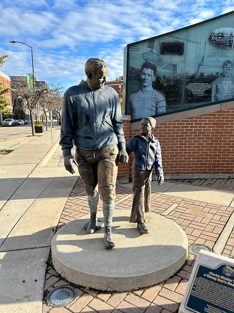 signs, sidewalk, sky, statues