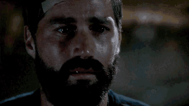 a man with a beard is crying with the words we have to go back behind him a man with a beard is crying with the words we have to go back behind him