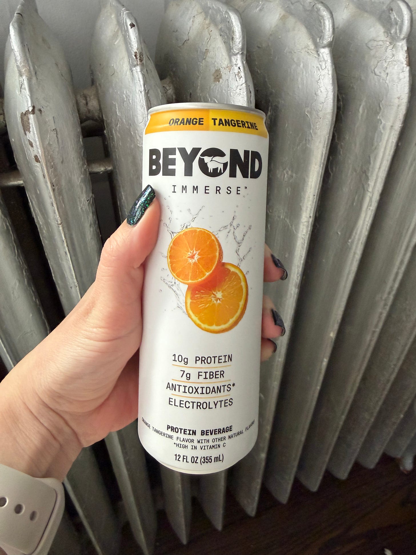 Long, thin can of Beyond Immerse in front of a metal radiator Long, thin can of Beyond Immerse in front of a metal radiator