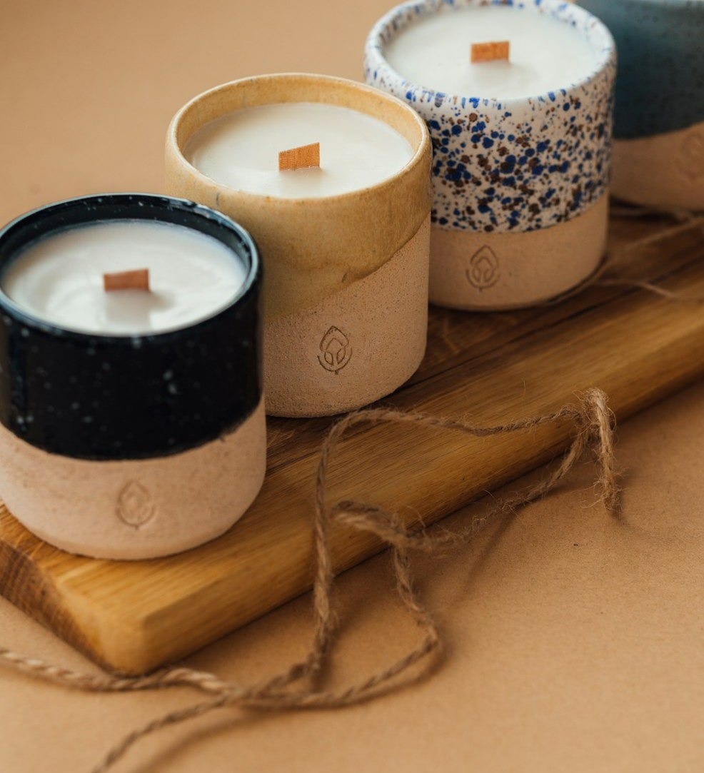 black and white candle on brown wooden holder
