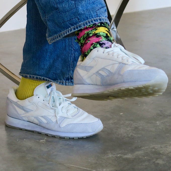 A person's feet in white sneakers and colorful socks
Description automatically generated A person's feet in white sneakers and colorful socks
Description automatically generated