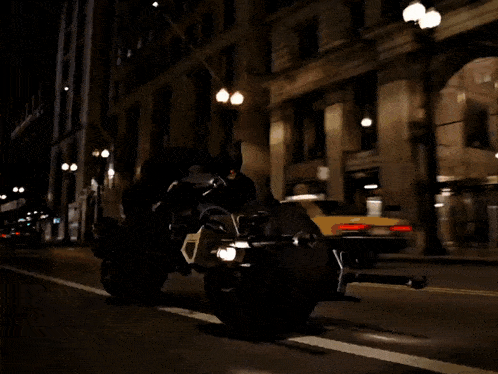 a person is riding a motorcycle on a city street