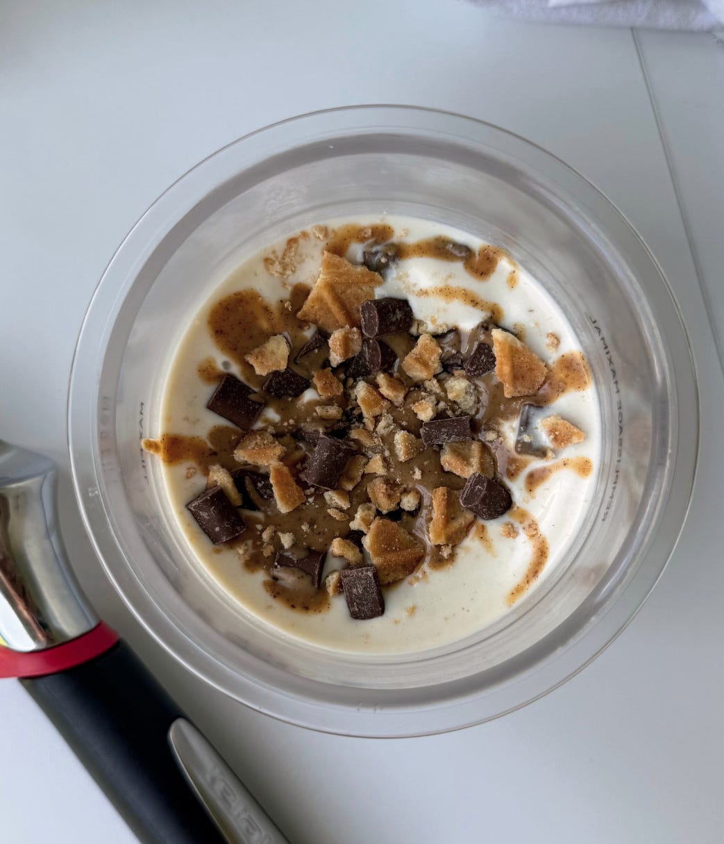 Overhead shot of a pint of homemade high-protein chocolate peanut butter cup ice cream made with Ninja Creami, showing smooth texture and peanut butter swirl